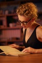 Purposeful young business woman, professional entrepreneur, reads a book. Business woman in a beautiful office in