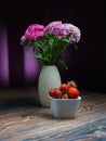 Purpura quae aster, It is a still life with serene asters, and fresh strawberries, on a wooden table, with a serene background. Royalty Free Stock Photo