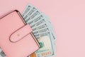 Purse with one hundred dollars banknotes on pink background. Flat lay, top view, copy space Royalty Free Stock Photo