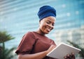 Pursue your passion with purpose. a young businesswoman using a digital tablet against a city background.