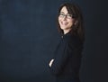 Pursue your passion and success will follow. Studio portrait of a corporate businesswoman posing against a dark