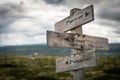 Pursue your passion text on wooden rustic signpost outdoors in nature/mountain scenery. Royalty Free Stock Photo