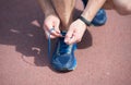 In pursuit of good health. Male hands lace sport shoe. Athletic shoe on arena ground. Gym shoe. Tying shoelaces Royalty Free Stock Photo