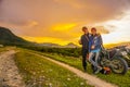 Purwakarta, West Java, Indonesia 03/30/2018 : Couple lover with his motorcycle enjoying such beautiful sunset in Jatiluhur Dam