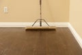 Push Broom on a Newly Installed Laminate Floor and Baseboard