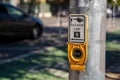 Push button cross walk intersection on light post with sign