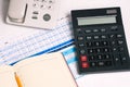 A push-button phone, a calculator, a notebook, and a graph with a table. Financial documents on the employee`s Desk. Royalty Free Stock Photo