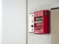 Push button switch, fire alarm on grey wall for alarm and security system with fire extinguisher port Royalty Free Stock Photo