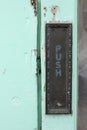 Push door plate on teal door