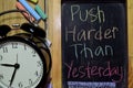 Push Harder Than Yesterday on phrase colorful handwritten on chalkboard