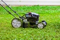 Push lawnmower in action with grass flying around/ Lawncare concept Royalty Free Stock Photo