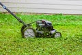 Push lawnmower in action with grass flying around/ Lawncare concept Royalty Free Stock Photo