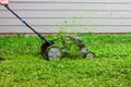 Push lawnmower in action with grass flying around/ Lawncare concept Royalty Free Stock Photo