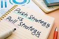 Push strategy vs pull strategy phrase in the notebook. Royalty Free Stock Photo