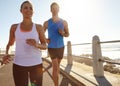 Push it to the limit. a young couple jogging together on the promenade. Royalty Free Stock Photo