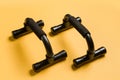 Push up bars on a yellow background close-up Royalty Free Stock Photo