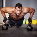 Push up on kettlebells man doing fitness training Royalty Free Stock Photo