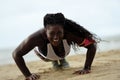 Push-ups fitness african woman doing pushups outside on beach