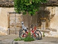 Pushbikes Resting on Orange Tree Outside old Greek House