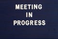 Meeting in Progress sign in plastic letters Royalty Free Stock Photo