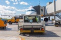 Pushing the airplane back the cart tow tracktor on the front landing gear of the chassis. Service and preparation for the flight. Royalty Free Stock Photo