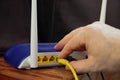 Pushing the cable into the wifi router for networking Royalty Free Stock Photo