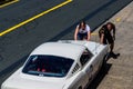 Young woman and man are pushing the racing car