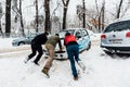 Pushing car in snow, Bucharest, Romania