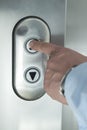 Pushing elevator up button Royalty Free Stock Photo