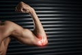 Pushing his body to the limit. Studio shot of a muscular young man flexing his bicep with cgi highlighting his elbow. Royalty Free Stock Photo