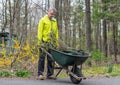 Pushing a Wheelbarrow In an American Garden