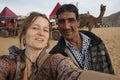 European tourist taking selfie with Indian friend