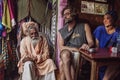 Street market fashion shop and coffee bar with Sadhu and tourists