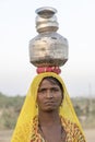 Indian poor woman with pots on her head on time Pushkar Camel Mela, Rajasthan, India, close up portrait Royalty Free Stock Photo