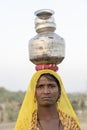 Indian poor woman with pots on her head on time Pushkar Camel Mela, Rajasthan, India, close up portrait Royalty Free Stock Photo