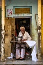 Indian tailor sewing with old sewing machine in the street of Pushkar, Rajasthan, India