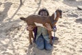 Indian young girl with goat in the desert near holy city Pushkar, Rajasthan, India, close up portrait Royalty Free Stock Photo