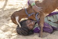 Indian young girl with goat in the desert near holy city Pushkar, Rajasthan, India, close up portrait Royalty Free Stock Photo