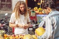 Tourist buying fruits on public market