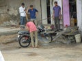 Bike washing outside rural Indian village motor repair shop