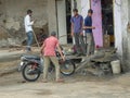 Bike washing outside rural Indian village motor repair shop