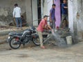 Bike washing outside rural Indian village motor repair shop