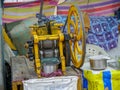 Old rustic sugarcane juice machine on street market stall. Royalty Free Stock Photo