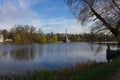 Chesma column, reflected in the Large lake of the Catherine Park, surrounded by trees. Against the blue Royalty Free Stock Photo