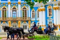 Tourists ride a horse-drawn carriage in Catherine park at Tsarskoe Selo in Pushkin, Russia Royalty Free Stock Photo