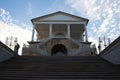 View from below of a wide staircase and a staircase with openwork railings leading to the gallery of