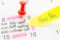 Pushpin on calendar with busy day. Royalty Free Stock Photo