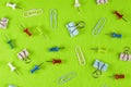 Pushpins paper clips and clips on a green cloth, top view Royalty Free Stock Photo