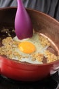 Put Egg on Red Pan, Cooking Process in the Kitchen Royalty Free Stock Photo