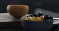 put fresh blueberries over thai mango in natural organic yogurt in blue bowl